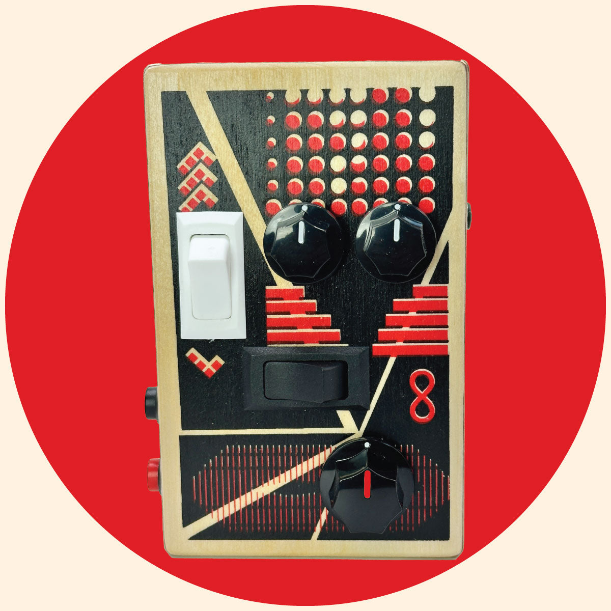 BrandNewNoise sound gadget with red and black art design, black control knobs, white and black rocker switches