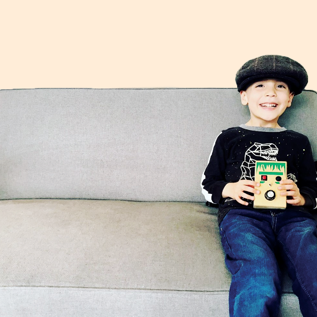 cute kid playing with voice record musical  toy with a fun Frankenstein design