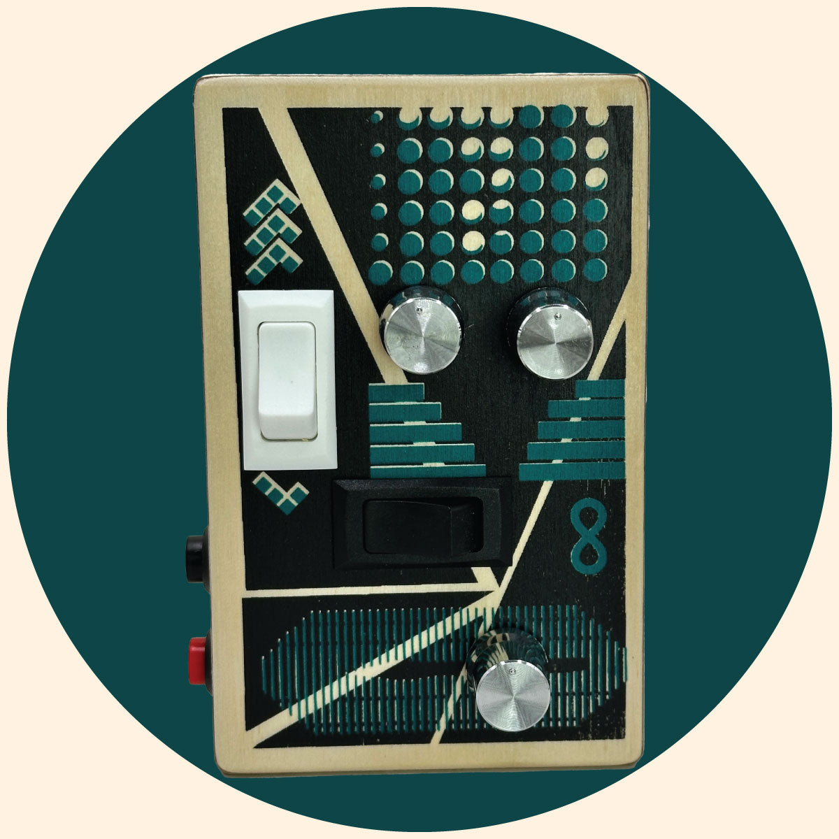 Reverse the Curse audio recording device with a sea green and black  graphic design,  silver control knobs,  white and black rocker switches